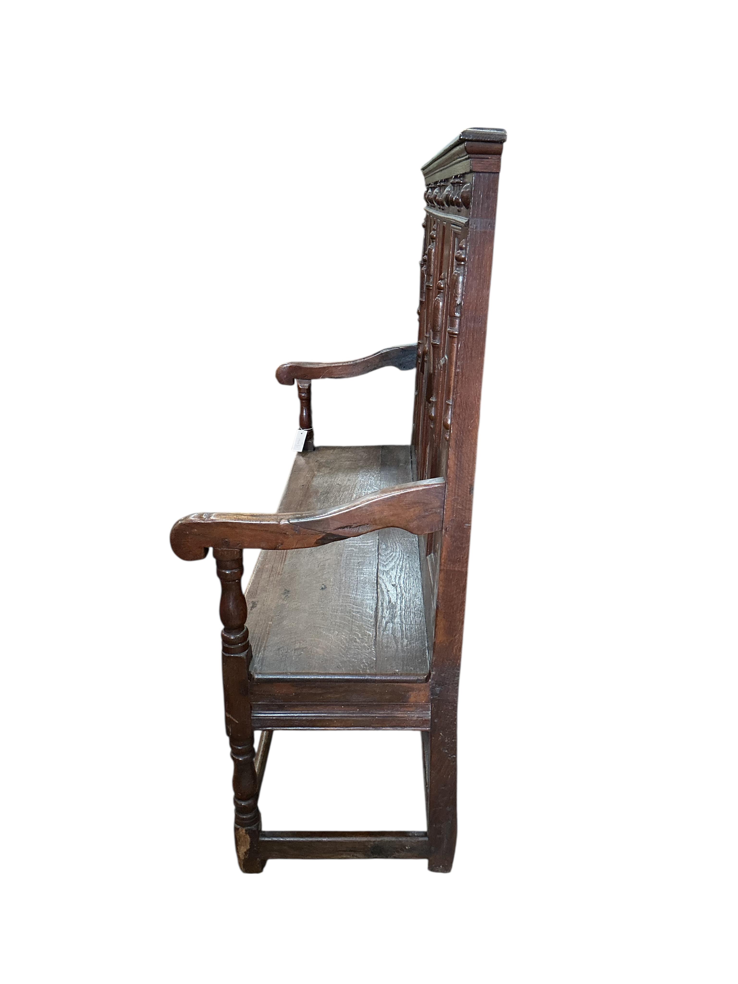 A Victorian panelled oak settle, width 173cm, depth 46cm, height 126cm